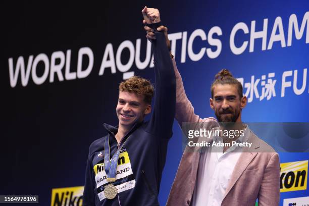 Gold medallist Leon Marchand of Team France is congratulated by Michael Phelps during the medal ceremony for the Men's 400m Individual Medley Final...