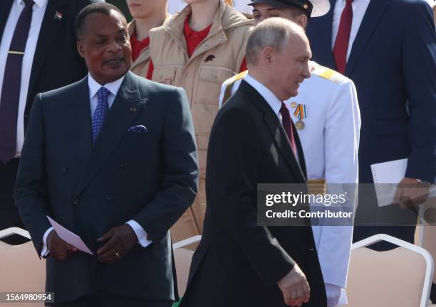 Republic of Congo President Dennis Fassou Nguesso looks at Russian President Vladimir Putin during during the annual Navy Day Parade on July 30 in...