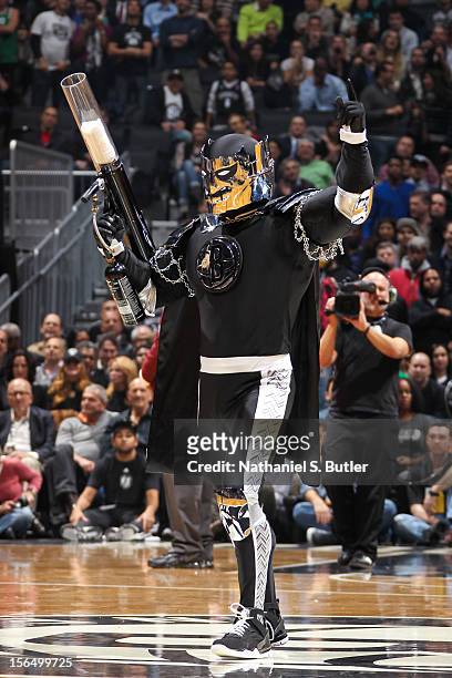 BrooklyKnight, the mascot of the Brooklyn Nets, fires T-shirts to fans during a game against the Boston Celtics on November 15, 2012 at the Barclays...