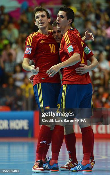 Miguelin of Spain celebrates with team mates Borja and Ortiz after winning the FIFA Futsal World Cup Semi-Final match between Italy and Spain at...