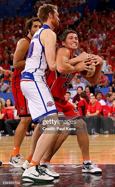 Damian Martin of the Wildcats gets fouled by Luke Schenscher of the 36'ers during the round seven NBL match between the Perth Wildcats and the...