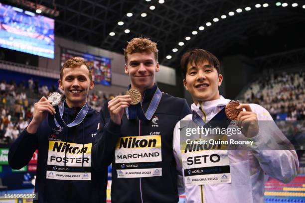 Silver medallist Carson Foster of Team United States , gold medallist Leon Marchand of Team France and bronze medallist Daiya Seto of Team Japan pose...