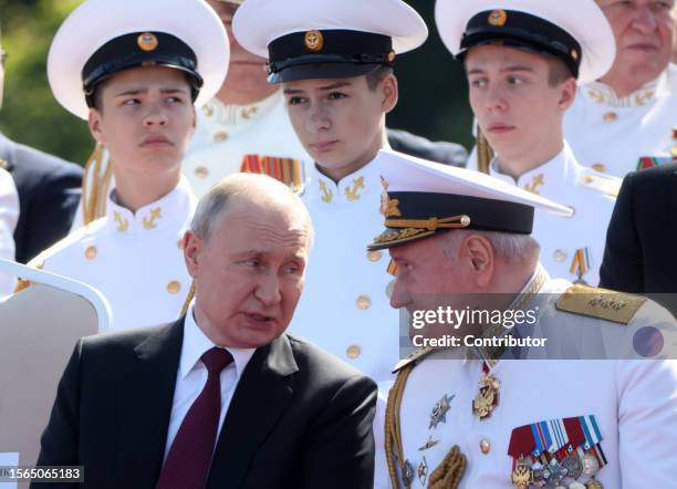 Russian President Vladimir Putin talks to the Russian Navy's Commander-in-Chief Nikolai Yevmenov during the annual Navy Day Parade on July 30 in...