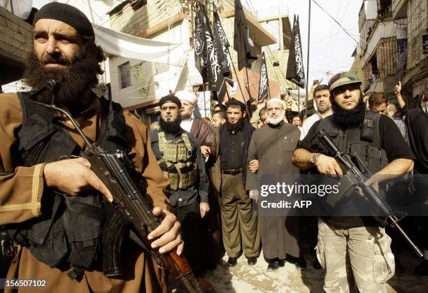 Armed Islamist Palestinian militants protect Sheikh Jamal Khattab , a Sunni cleric who heads the Haraka Islamiyya Mujahida , during a demonstration...