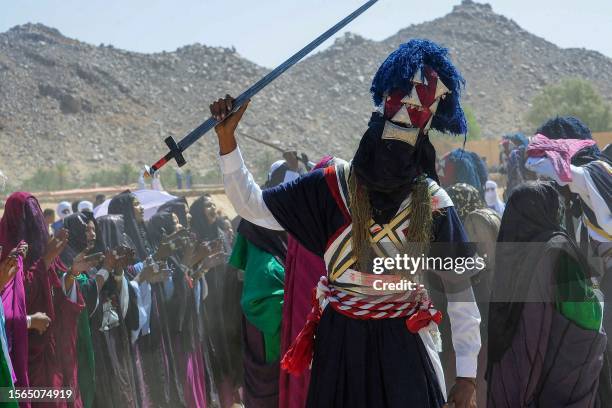 Men and women perform a traditional dance during the Sebeiba Festival, a yearly celebration of Tuareg culture, in the oasis town of Djanet in...