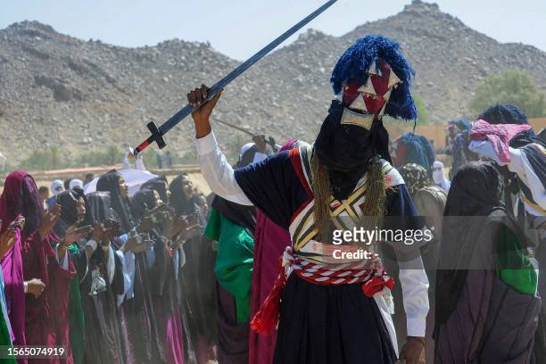 Men and women perform a traditional dance during the Sebeiba Festival, a yearly celebration of Tuareg culture, in the oasis town of Djanet in...