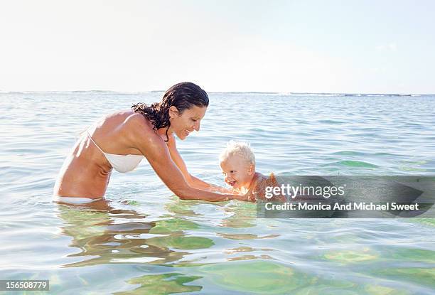 happy mother and son having fun at the beach - één ouder stockfoto's en -beelden