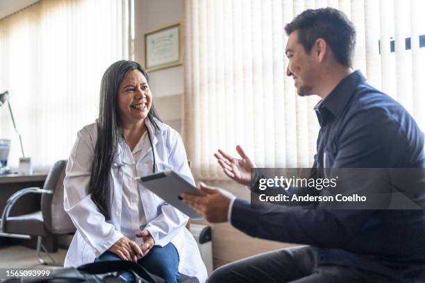 vertriebsmitarbeiter und japanische ärztin im gespräch - handelsvertreter für medizinprodukte stock-fotos und bilder