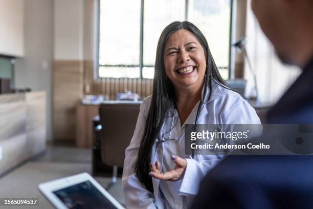 sales representative and japanese female doctor talking - medical sales representative stock pictures, royalty-free photos & images