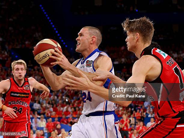Nathan Crosswell of the 36ers gets fouled by Cameron Tovey of the Wildcats during the round seven NBL match between the Perth Wildcats and the...