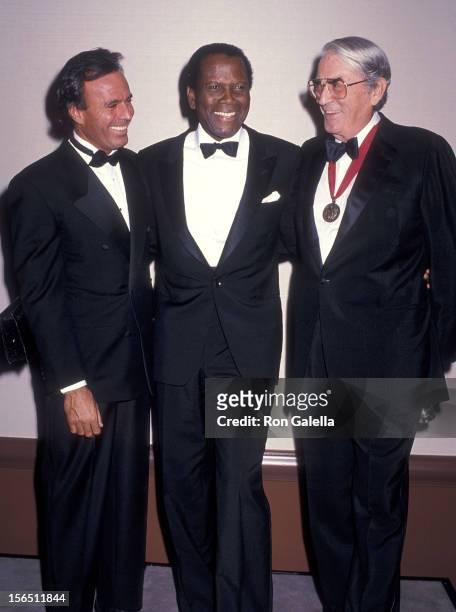 Singer Julio Iglesias, actor Sidney Poitier and actor Gregory Peck attend the American Friends of the Hebrew University's 19th Annual Scopus Award...