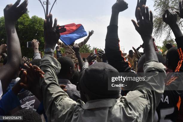 Protesters cheer Nigerien troops as they gather in front of the French Embassy in Niamey during a demonstration that followed a rally in support of...