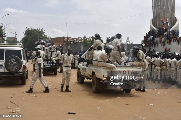 Nigerien policemen are seen as supporters rally in support of Niger's junta in Niamey on July 30, 2023. Thousands of people demonstrated in front of...