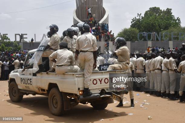 Nigerien policemen are seen as supporters rally in support of Niger's junta in Niamey on July 30, 2023. Thousands of people demonstrated in front of...