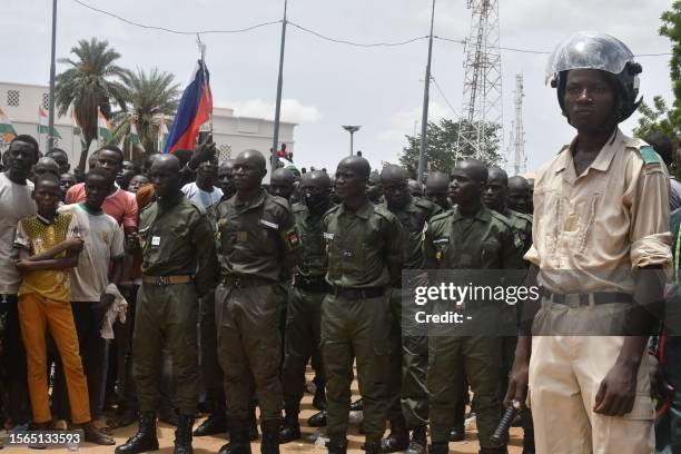 Nigerien policeman stands as Nigerien cadets paradeas supporters rally in support of Niger's junta in Niamey on July 30, 2023. Thousands of people...