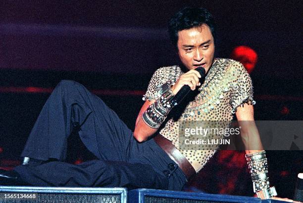 Hong Kong's king of pop, singer Leslie Cheung sings during his solo concert at Shanghai Stadium late 16 September 2000. Cheung retired from singing...
