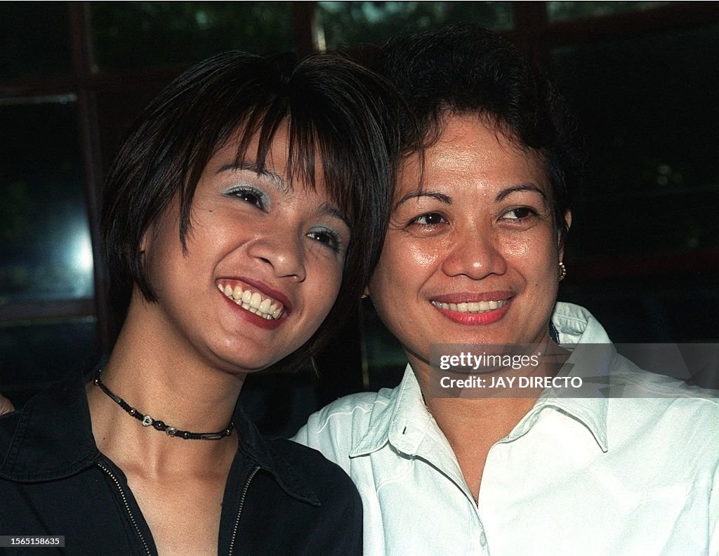 Former Filipina maid Sarah Balabagan poses for a photo with an... News
