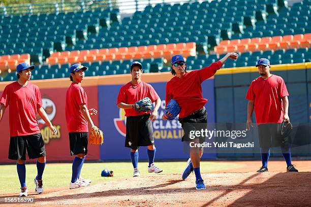 Geno Espinelli of Team Philippines throws in the bullpen in front of teammates during the workout day for the 2013 World Baseball Classic Qualifier...