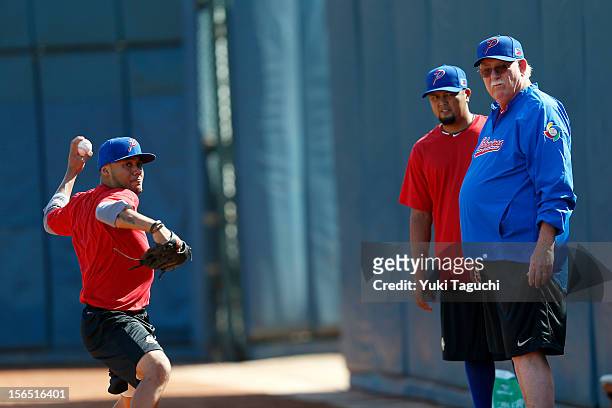Devon Ramirez of Team Philippines throws in the bullpen in front of Charlie Labrador of Team Philippines and coach Billy Champion during the workout...