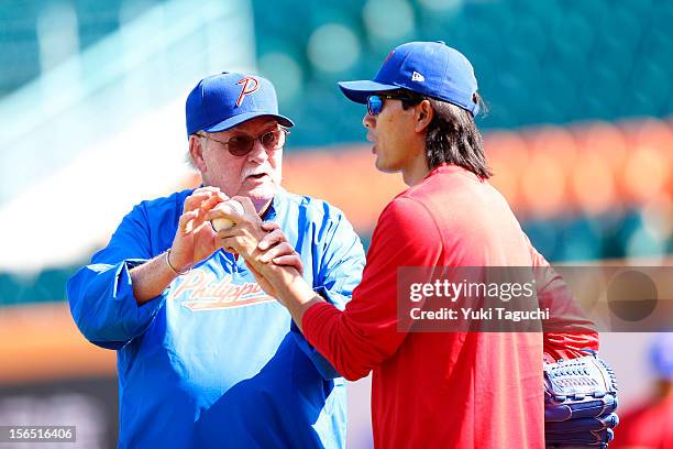 Billy Champion coach of Team Philippines talks pitching with Geno Espinelli of Team Philippines during the workout day for the 2013 World Baseball...