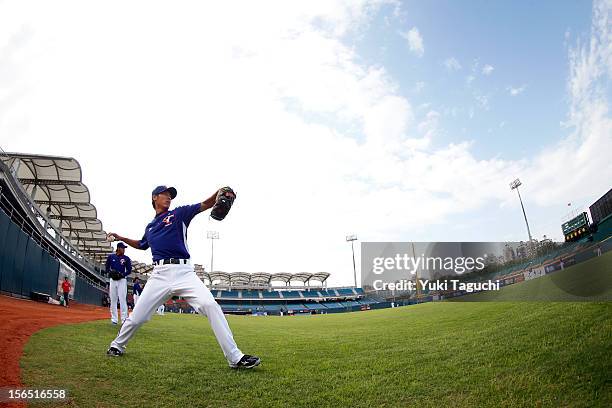 Ta-Yuan Kuan of Team Chinese Taipei throws in the outfield during the workout day for the 2013 World Baseball Classic Qualifier at Xinzhuang Stadium...