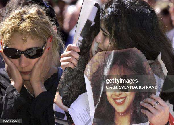 Fans of Israeli singer Ofra Haza mourn as they stand in front of her coffin at a pre-funeral ceremony in Tel Aviv 24 February 2000. The coffin,...