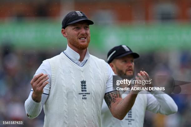 England's captain Ben Stokes leaves the field as play is stopped by rain on day four of the fifth Ashes cricket Test match between England and...