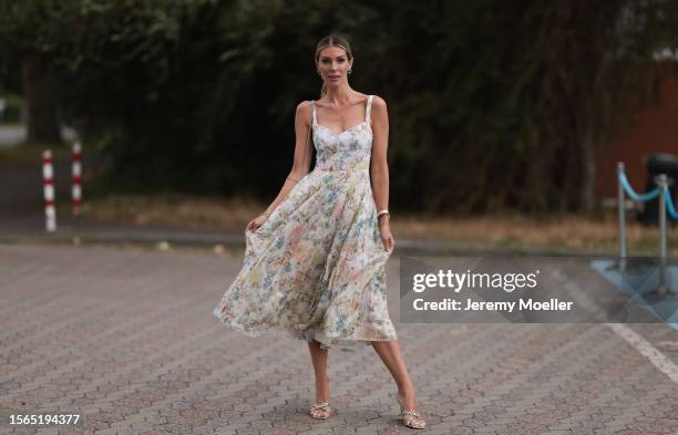 Annika Gassner is seen wearing a pastel floral midi dress, a beige bag and glitter pumps outside during the Riani Cruise 2023 on July 22, 2023 in...