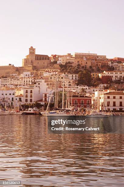 golden early morning light falls on old town ibiza - ibiza town stock pictures, royalty-free photos & images