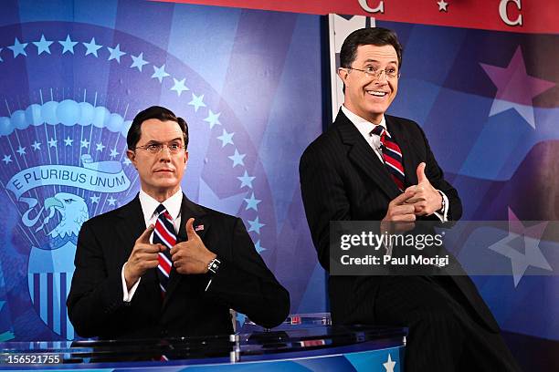 Stephan Colbert poses for photos with his wax figure at the Stephen Colbert wax figure unveiling at Madame Tussauds on November 16, 2012 in...