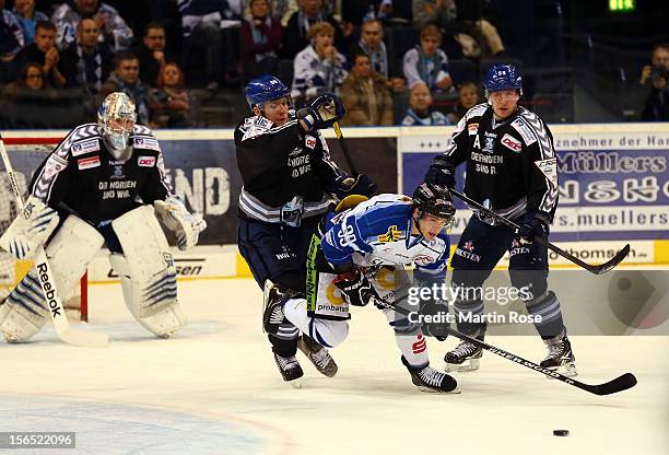 David Wolf of Hamburg battles for the puck with Michael Endrass of Straubing during the DEL match between Hamburg Freezers and Straubing Tigers on...