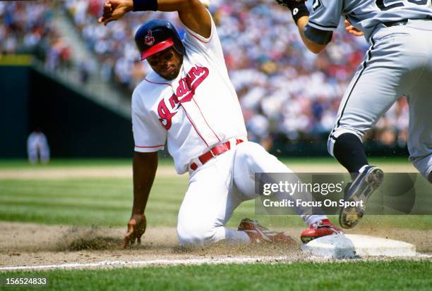 Albert Belle of the Cleveland Indians slides into third base safe against the Chicago White Sox during an Major League Baseball game circa 1994 at...