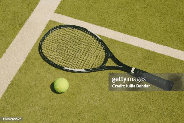 tennis racket on green fields - racchetta da tennis foto e immagini stock