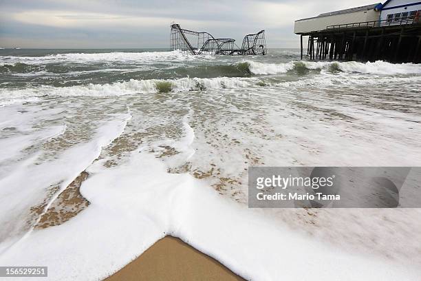 Waves break in front of a destroyed roller coaster on November 16, 2012 in Seaside Heights, New Jersey. Two amusement piers and a number of roller...