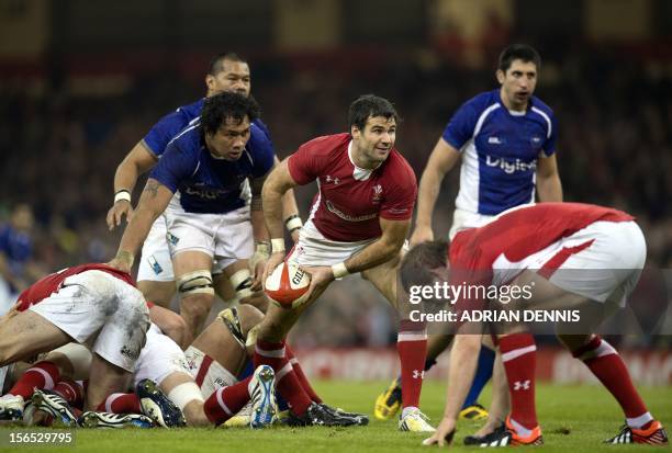 Wales' scrum half Mike Phillips passes the ball from the back of a ruck against Samoa during their International Rugby Union match at The Millennium...