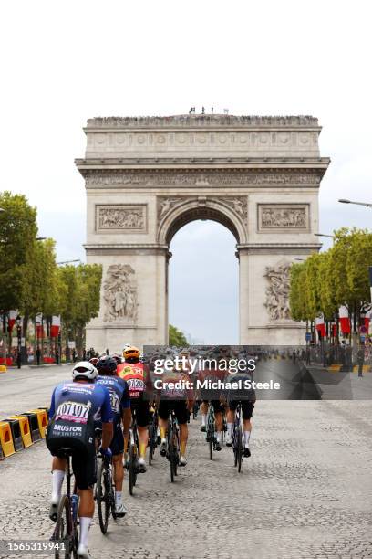 General view of the peloton passing through the Champs Elysees with the The Arc de Triomf in the background during the stage twenty-one of the 110th...