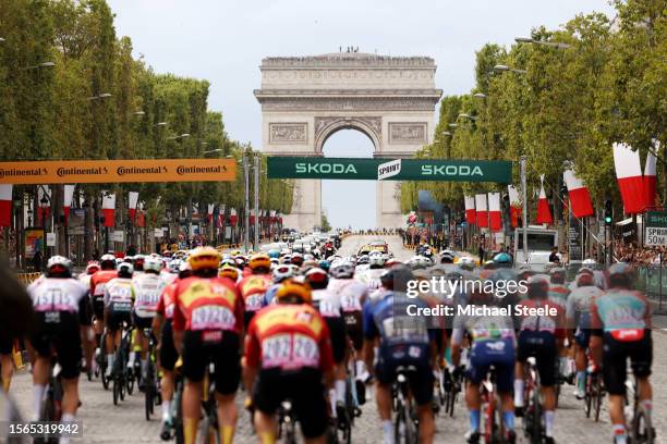 General view of the peloton passing through the Champs Elysees with the The Arc de Triomf in the background during the stage twenty-one of the 110th...