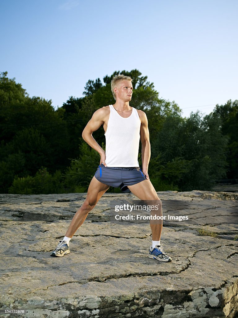 Young man stretching after running
