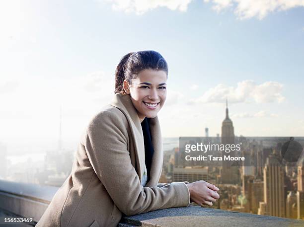 young business woman with city in background - businesswoman nyc stock pictures, royalty-free photos & images