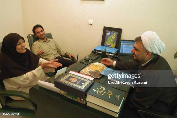 Jafar Savalanpour Ardabili, a marriage consultant, talks in his Tehran office with a young couple who got married over a year ago and have come for...