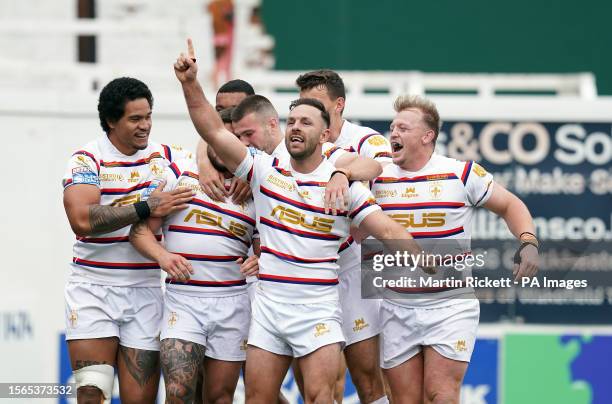 Wakefield Trinity's Liam Hood celebrates scoring a try with team-mates including Luke Gale during the Betfred Super League match at the Be Well...