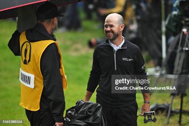 Brian Harman of the United States celebrates on the 18th green alongside Caddie Scott Tway after victory on Day Four of The 151st Open at Royal...