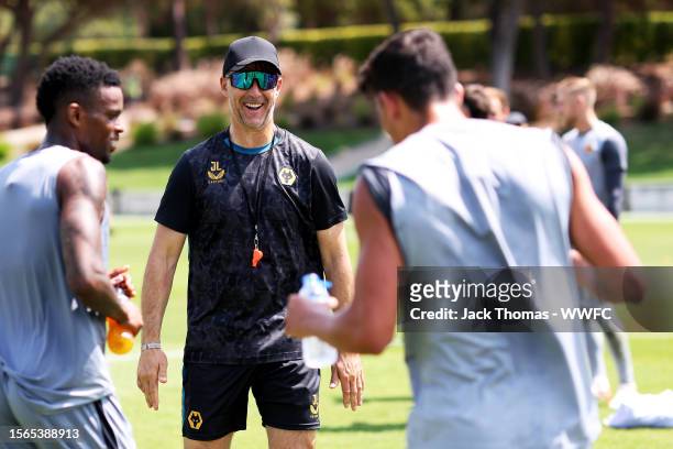 Julen Lopetegui, Manager of Wolverhampton Wanderers reacts as he speaks with Nelson Semedo and Matheus Nunes during a pre-season training camp on...