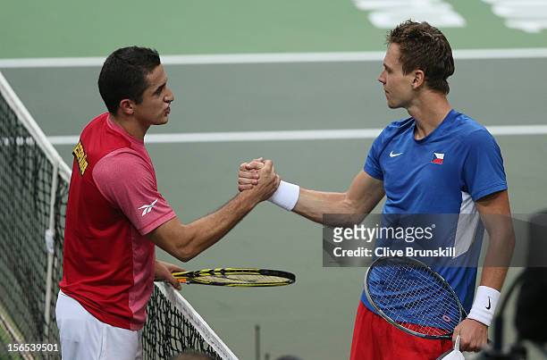 Tomas Berdych of Czech Republic shakes hands at the net with Nicolas Almagro of Spain after his five set win in the second rubber during day one of...