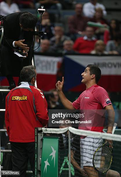Nicolas Almagro of Spain and his team captain Alex Corretja make a point to umpire Carlos Ramos during his match against Tomas Berdych of Czech...