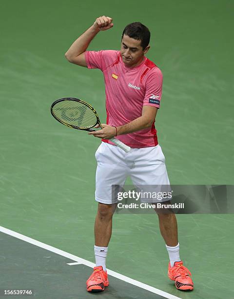 Nicolas Almagro of Spain punches his racket in frustration during his 5 set match against Tomas Berdych of Czech Republic during day one of the final...