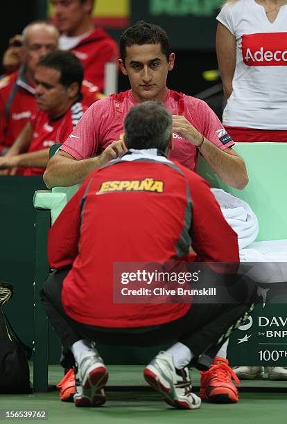 Nicolas Almagro of Spain listens to his team captain Alex Corretja during his match against Tomas Berdych of Czech Republic during day one of the...