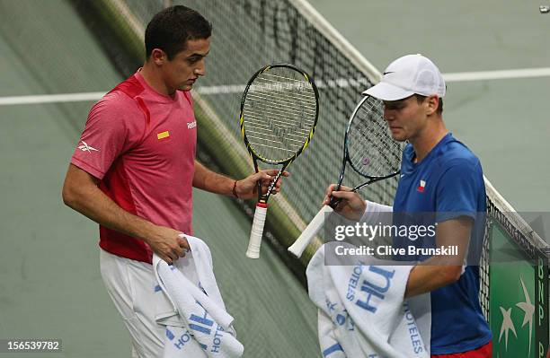 Tomas Berdych of Czech Republic meets at the net with Nicolas Almagro of Spain during a change of ends in the second rubber during day one of the...