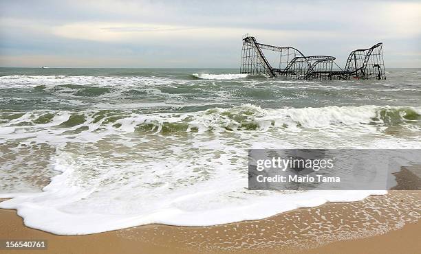 Waves break around a destroyed roller coaster on November 16, 2012 in Seaside Heights, New Jersey. Two amusement piers and a number of roller...