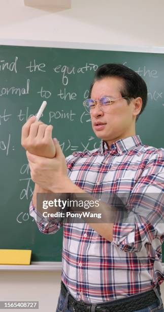 male professor has wrist pain - writing hand cramp stock pictures, royalty-free photos & images